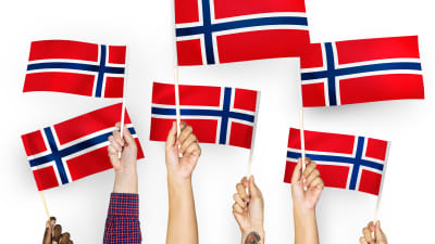 Hands waving flags of norway